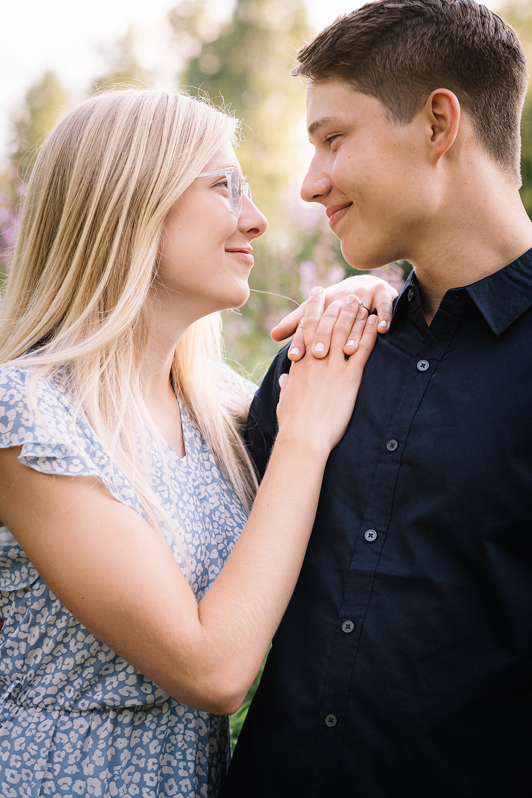 Sophie and William Winters smiling at each other in a blooming garden — the husband and wife duo behind Winters Wedding Melodies